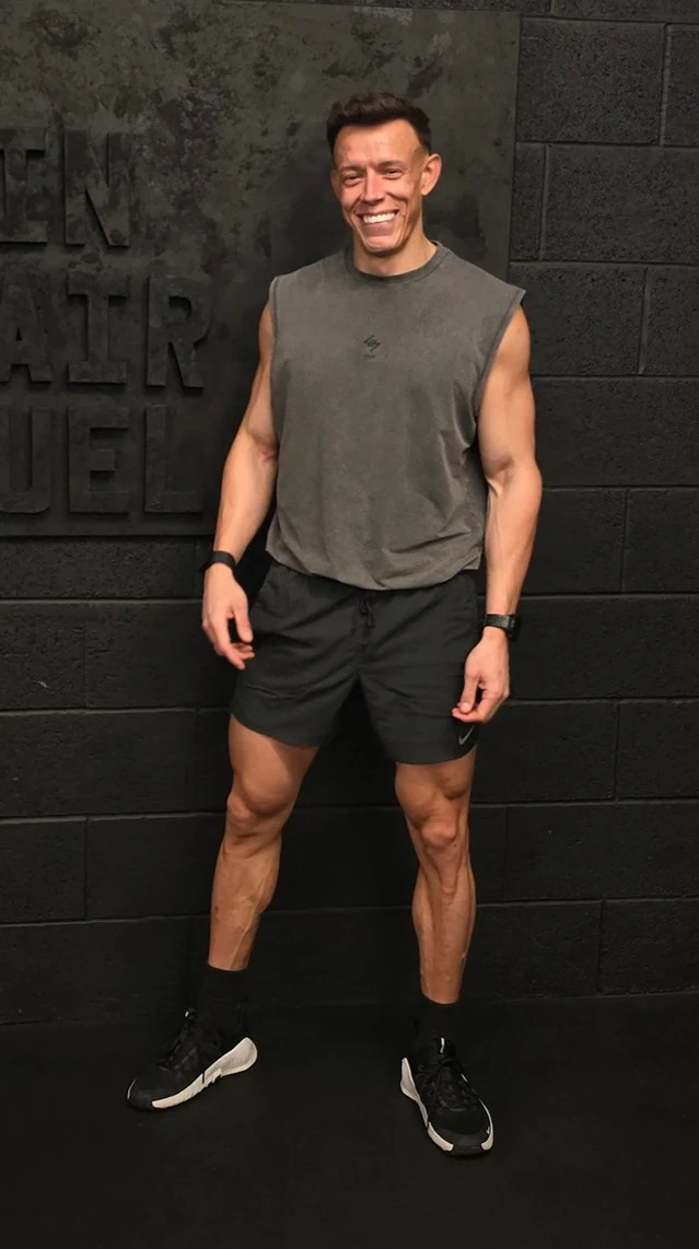 Kurtis, FORTE FITNESS personal trainer and coach, smiling in the gym